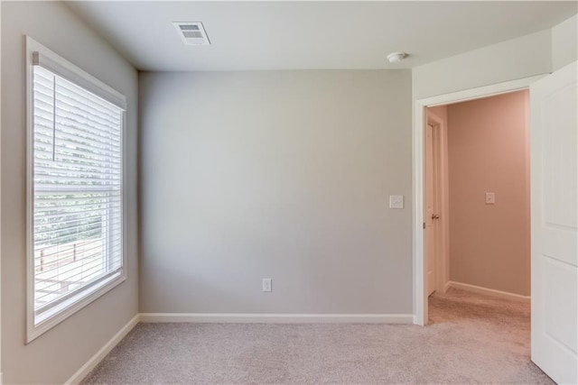 6410 Crosscreek Ln, Flowery Branch, GA 30542 - empty room with plenty of natural light, light colored carpet, and a smoke detector