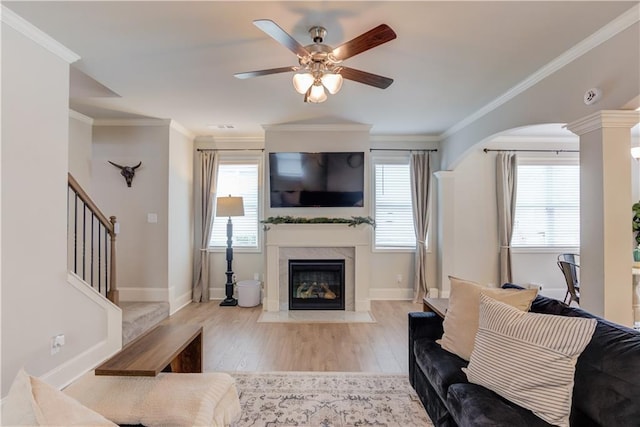 6410 Crosscreek Ln, Flowery Branch, GA 30542 - living room featuring a high end fireplace, a ceiling fan, wood finished floors, stairway, and crown molding
