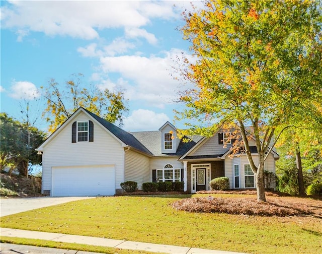 view of front of home with a front lawn and a garage