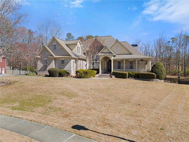 view of front of house with a porch and a front yard