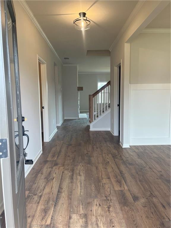 entryway with visible vents, baseboards, stairway, ornamental molding, and wood finished floors