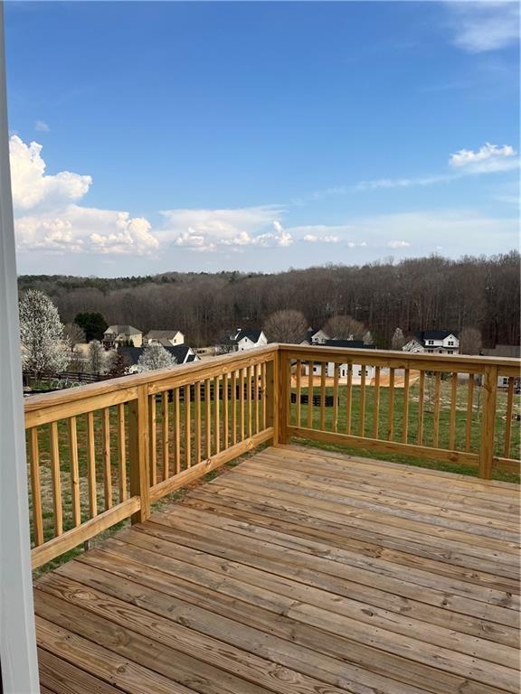 wooden terrace with a wooded view