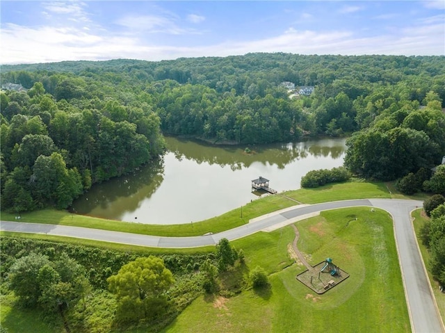 birds eye view of property featuring a view of trees and a water view