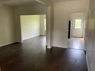 spare room with dark hardwood / wood-style flooring