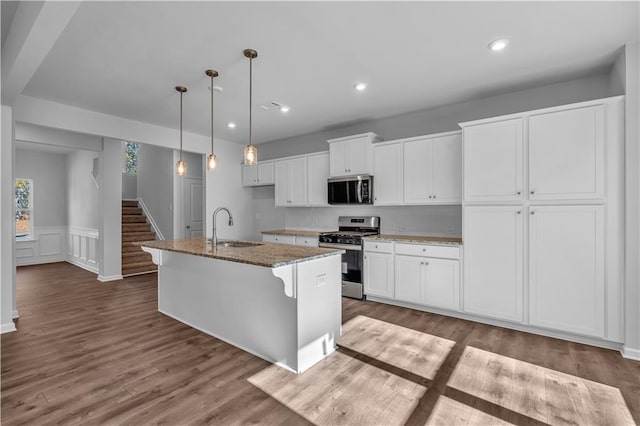 16 Grove Pointe Way SE, Cartersville, GA 30120 - kitchen featuring appliances with stainless steel finishes, a sink, a kitchen island with sink, white cabinetry, and stone counters