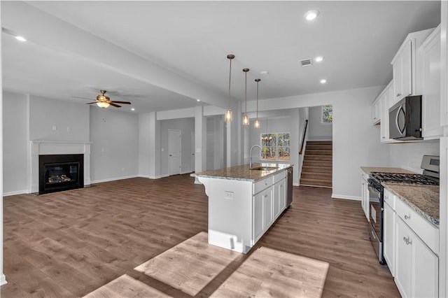 16 Grove Pointe Way SE, Cartersville, GA 30120 - kitchen with appliances with stainless steel finishes, a sink, white cabinetry, light stone counters, and ceiling fan