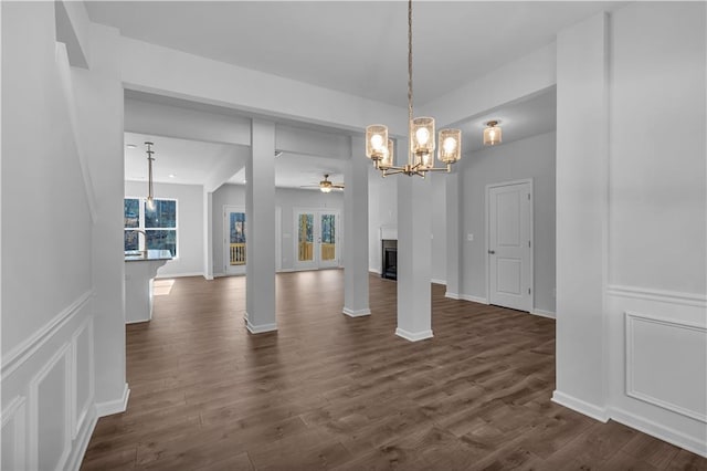 16 Grove Pointe Way SE, Cartersville, GA 30120 - unfurnished dining area with a ceiling fan, a chandelier, dark wood-style flooring, a fireplace, and baseboards