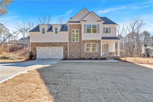 16 Grove Pointe Way SE, Cartersville, GA 30120 - view of front facade with board and batten siding, driveway, stone siding, an attached garage, and central AC
