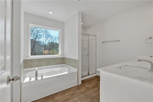 16 Grove Pointe Way SE, Cartersville, GA 30120 - bathroom with a stall shower, wood finished floors, a sink, and a garden tub