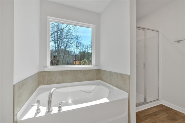 16 Grove Pointe Way SE, Cartersville, GA 30120 - bathroom featuring a shower stall, a bath, and wood finished floors