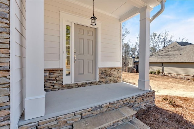 16 Grove Pointe Way SE, Cartersville, GA 30120 - view of exterior entry featuring covered porch, stone siding, and central air condition unit
