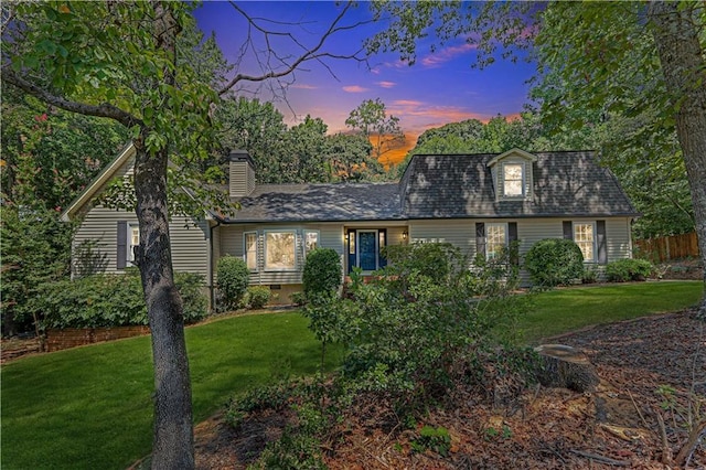 new england style home with a yard