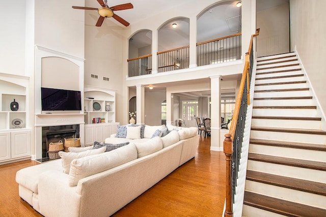 3631 Guinevere Trce, Douglasville, GA 30135 - living area with a ceiling fan, wood finished floors, a high ceiling, stairway, and built in features