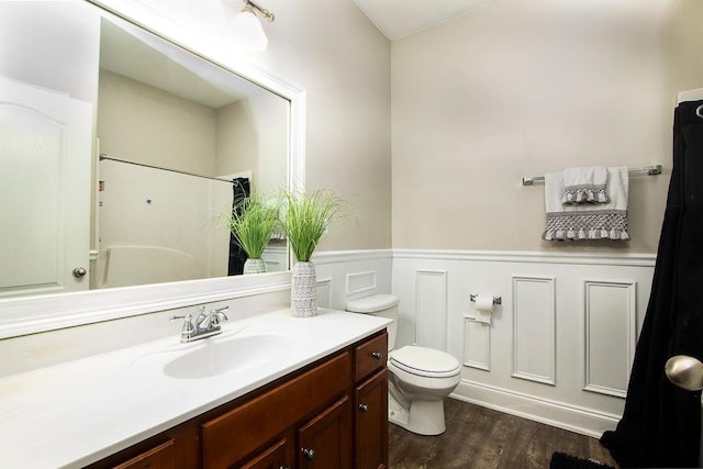 3631 Guinevere Trce, Douglasville, GA 30135 - full bath featuring vanity, a wainscoted wall, toilet, wood finished floors, and a shower with curtain