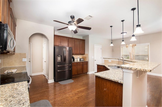 3631 Guinevere Trce, Douglasville, GA 30135 - kitchen featuring appliances with stainless steel finishes, a sink, arched walkways, a ceiling fan, and tasteful backsplash