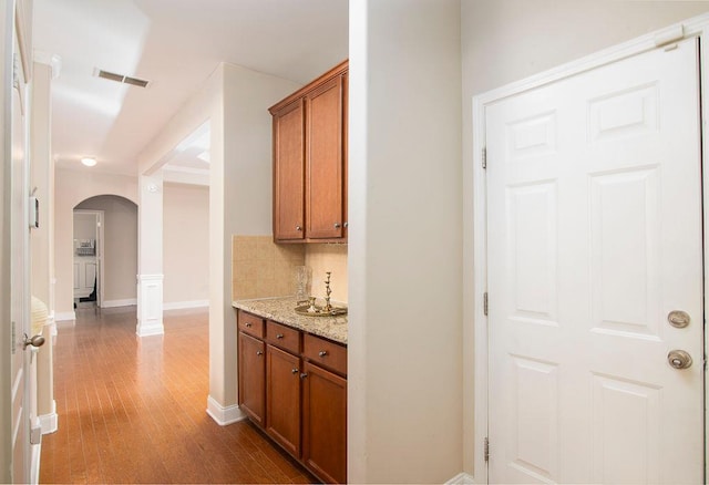 3631 Guinevere Trce, Douglasville, GA 30135 - bar area with arched walkways, wood finished floors, tasteful backsplash, and baseboards