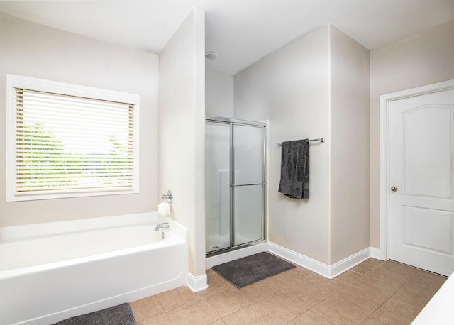3631 Guinevere Trce, Douglasville, GA 30135 - bathroom with a garden tub, a stall shower, baseboards, and tile patterned floors