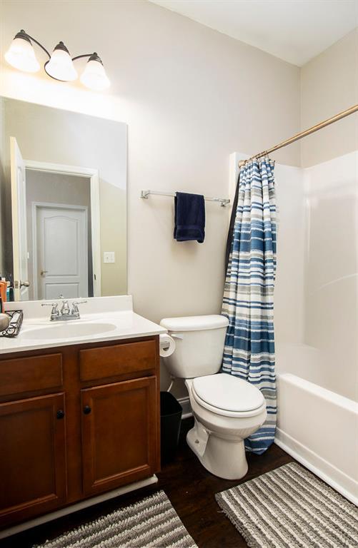 3631 Guinevere Trce, Douglasville, GA 30135 - bathroom with toilet, vanity, wood finished floors, and shower / tub combo