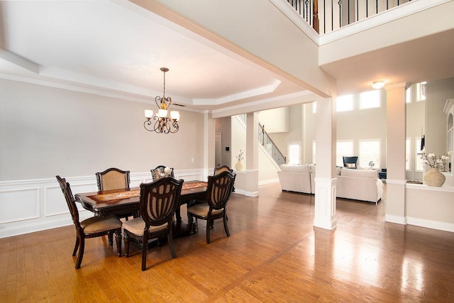3631 Guinevere Trce, Douglasville, GA 30135 - dining space featuring a raised ceiling, stairway, light wood finished floors, and a chandelier