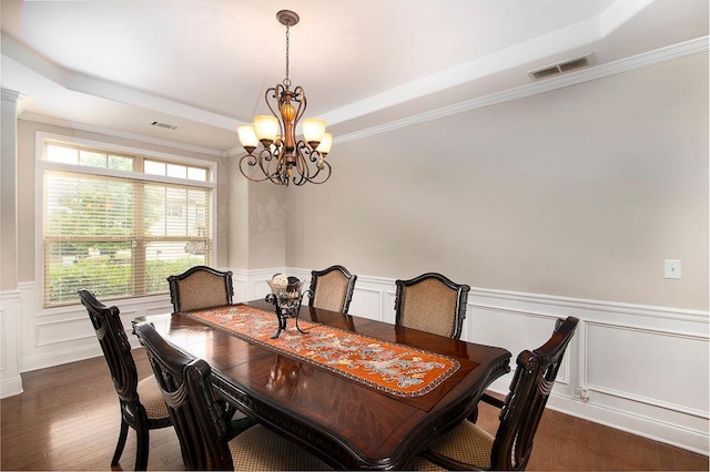 3631 Guinevere Trce, Douglasville, GA 30135 - dining space featuring a tray ceiling, a chandelier, dark wood-style floors, a decorative wall, and a wainscoted wall
