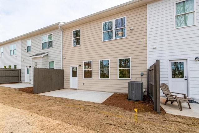 back of property with central AC unit and a patio area