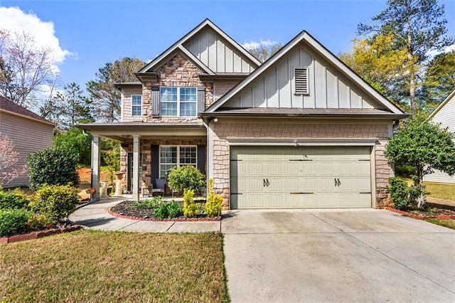 craftsman-style home featuring board and batten siding, covered porch, driveway, an attached garage, and stone siding