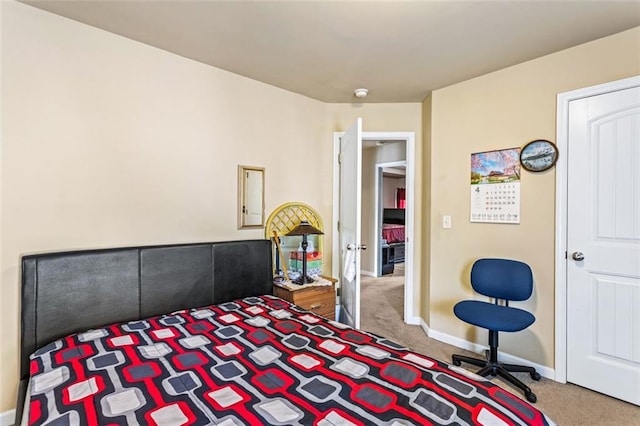 carpeted bedroom with baseboards