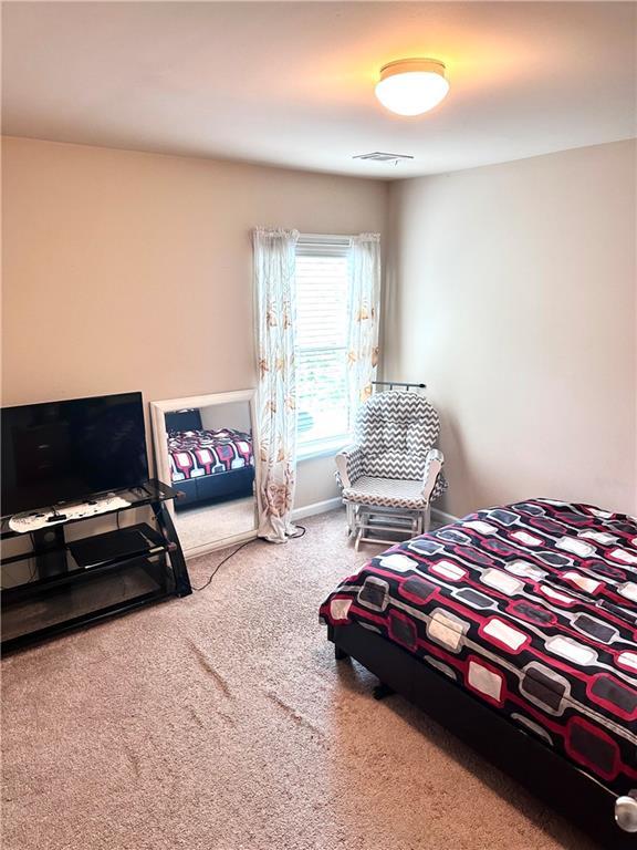 bedroom with carpet floors and visible vents
