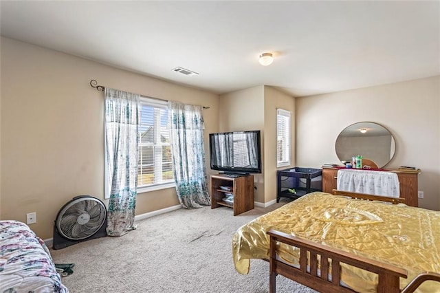 bedroom with baseboards, carpet flooring, and visible vents