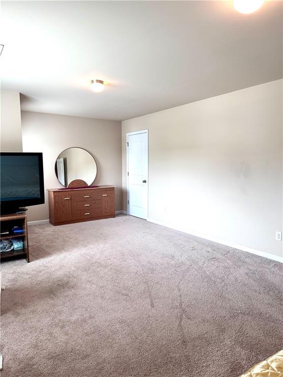 unfurnished bedroom with baseboards and carpet flooring