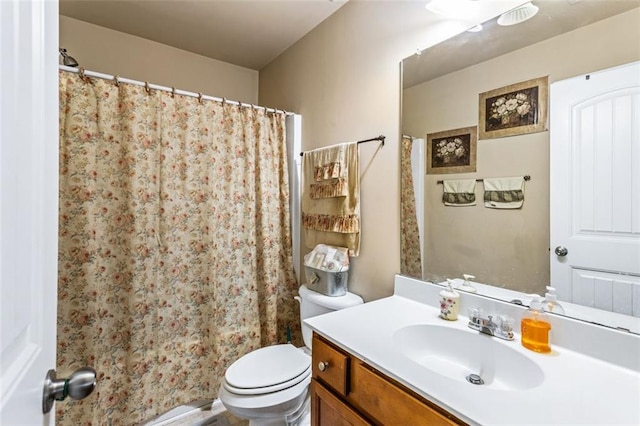bathroom featuring vanity, curtained shower, and toilet
