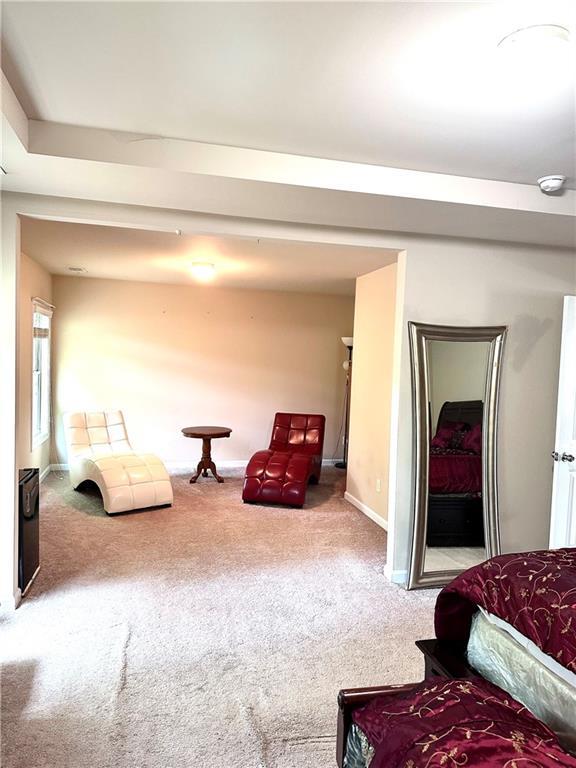 sitting room with carpet floors and baseboards