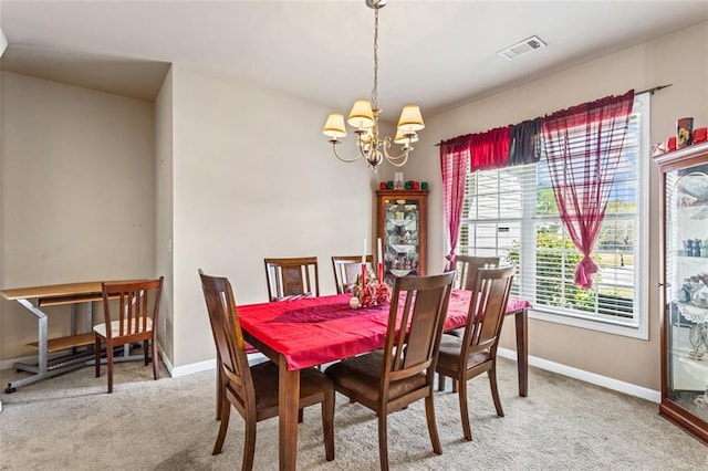 dining space with visible vents, baseboards, an inviting chandelier, and carpet
