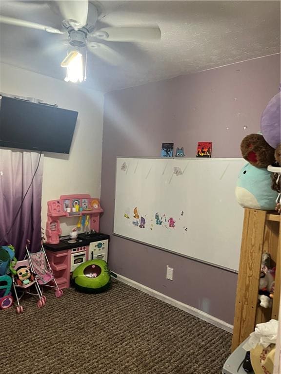 recreation room featuring ceiling fan and carpet flooring