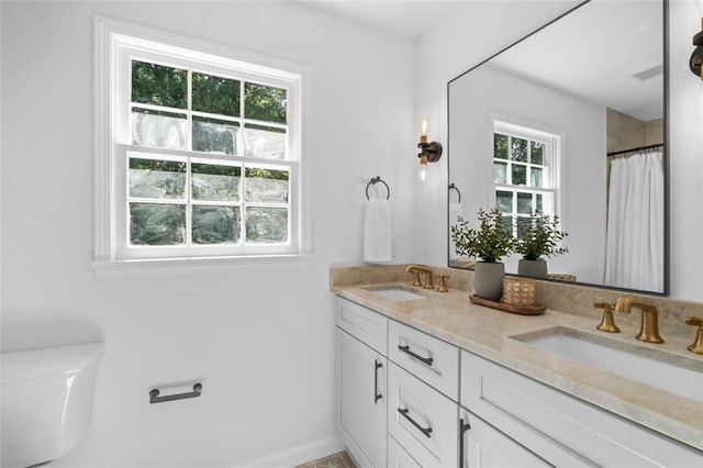 5143 Meadowlake Ln, Dunwoody, GA 30338 - bathroom with plenty of natural light, baseboards, double vanity, and a shower with shower curtain