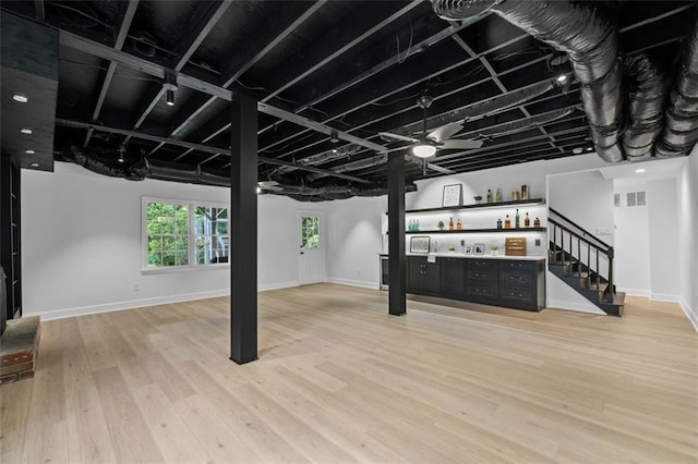 5143 Meadowlake Ln, Dunwoody, GA 30338 - below grade area with a dry bar, light wood-style floors, and baseboards