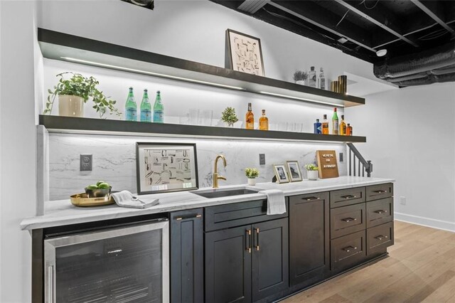 5143 Meadowlake Ln, Dunwoody, GA 30338 - indoor wet bar featuring beverage cooler, light wood-style flooring, and baseboards