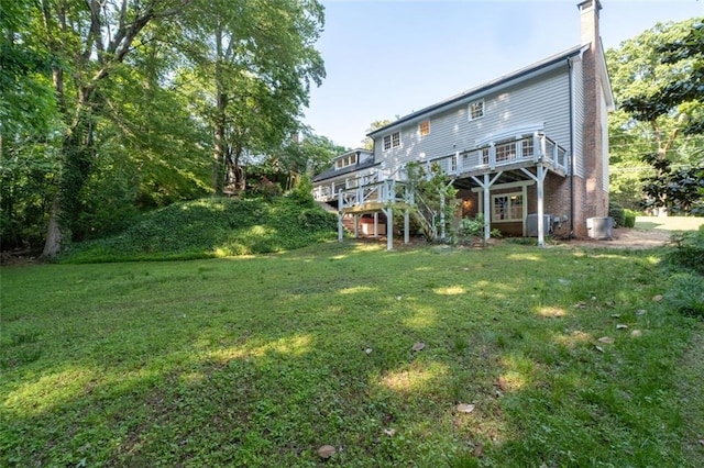 5143 Meadowlake Ln, Dunwoody, GA 30338 - rear view of house featuring stairs, a deck, a yard, a chimney, and central AC unit