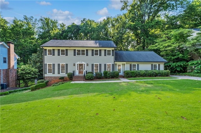 5143 Meadowlake Ln, Dunwoody, GA 30338 - colonial house featuring a front lawn and central AC unit