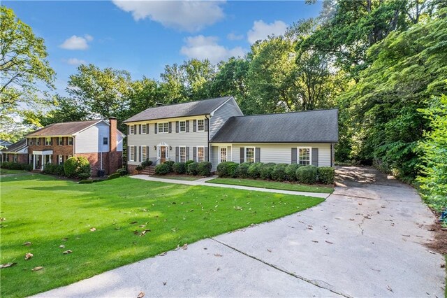 5143 Meadowlake Ln, Dunwoody, GA 30338 - colonial house with asphalt driveway and a front yard