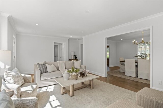 5143 Meadowlake Ln, Dunwoody, GA 30338 - living area featuring wood finished floors, a chandelier, recessed lighting, baseboards, and crown molding