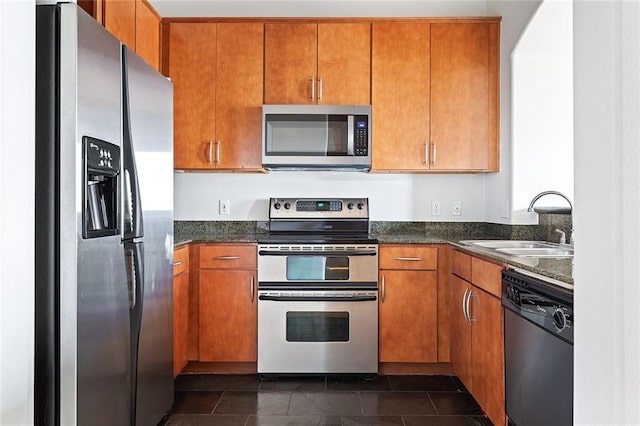3445 Stratford Rd NE Unit 1605, Atlanta, GA 30326 - kitchen with stainless steel appliances, a sink, brown cabinetry, and dark stone countertops