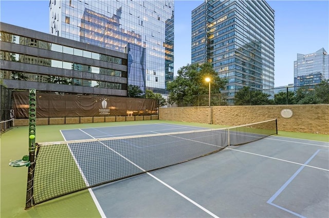 view of sport court with a view of city, community basketball court, and fence