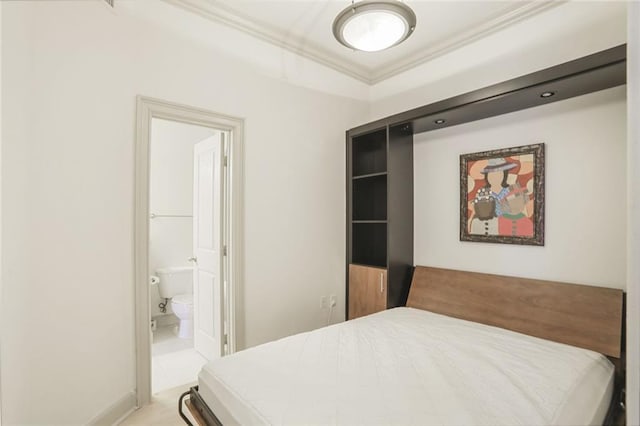 tiled bedroom featuring ensuite bathroom and crown molding