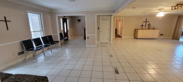 interior space with ornamental molding, light tile patterned flooring, and ceiling fan