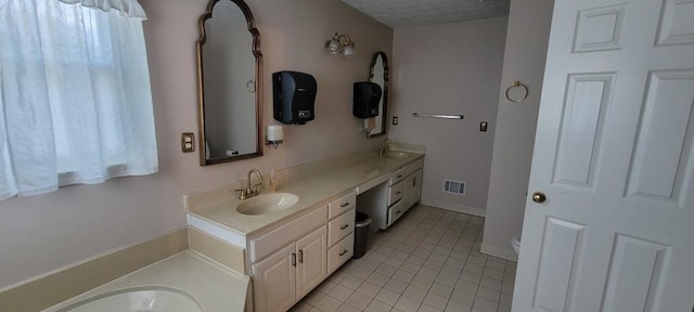 bathroom with tile patterned flooring and vanity