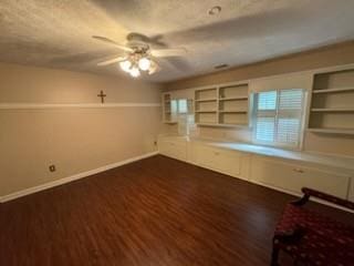 interior space featuring ceiling fan and dark hardwood / wood-style flooring