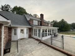 rear view of property with a patio area and a sunroom