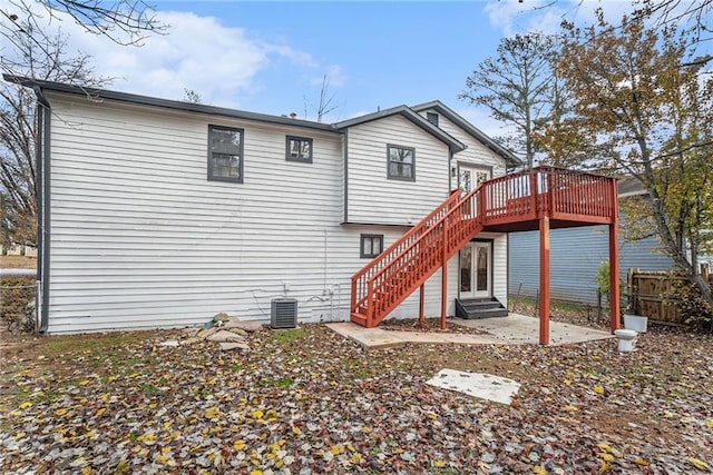 back of property featuring a wooden deck, a patio, and central AC unit