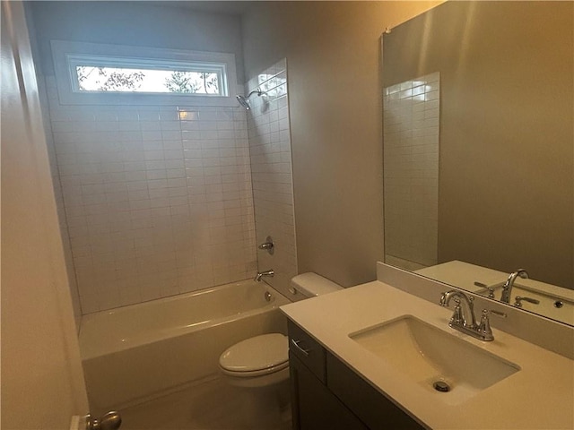 full bathroom featuring tiled shower / bath, toilet, and vanity